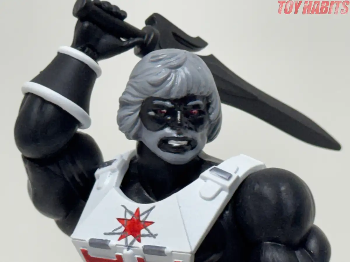A closer look at the unmasked head highlights the red eyes, sculpted facial features, and silver-gray beard.