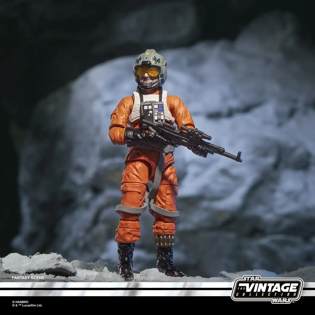 Trapper Wolf wearing his gray X-wing pilot helmet and holding a blaster