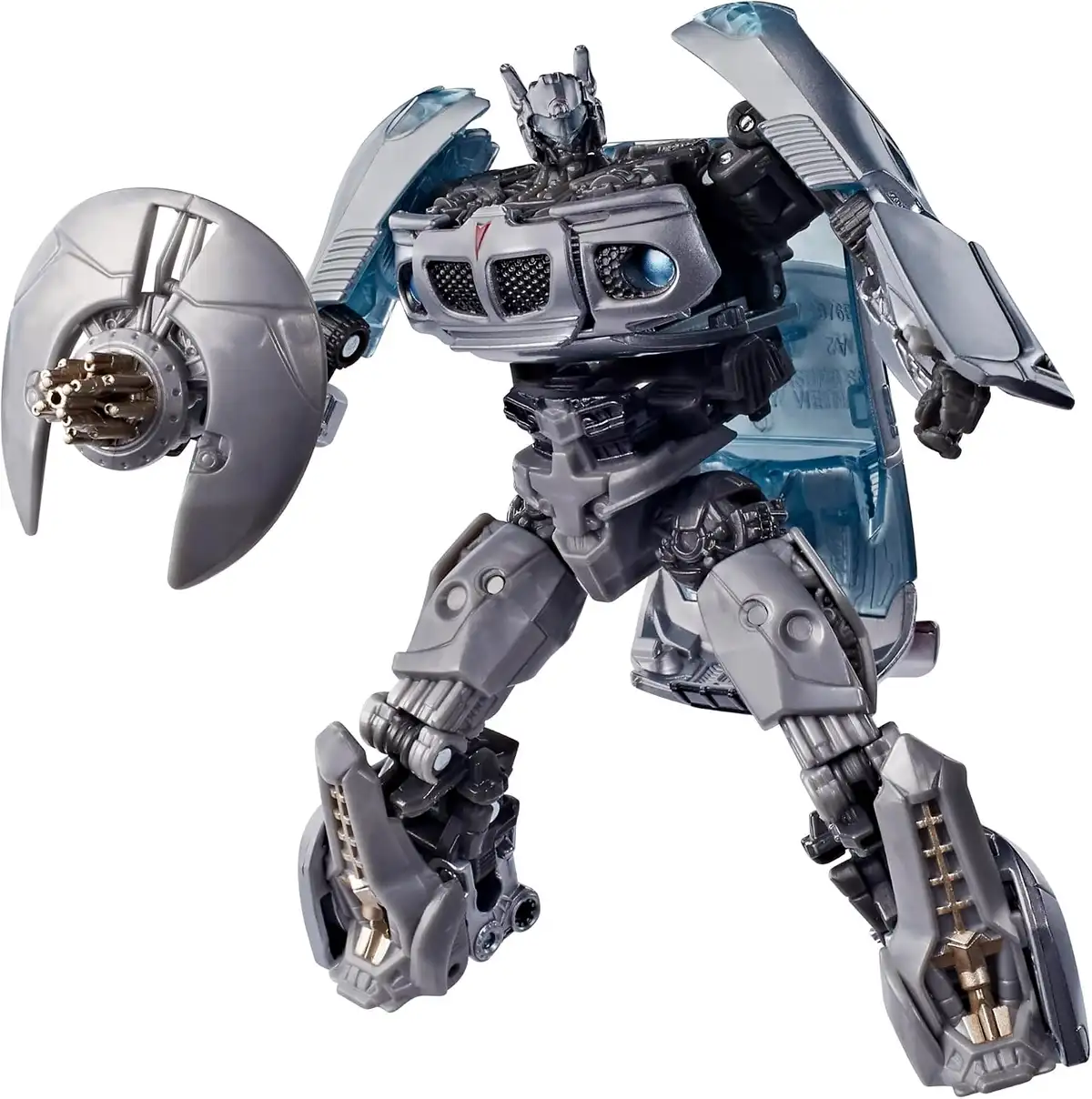 Jazz has silver body panels, blue-tinted windows across his chest, and wheel components on his legs. A circular silver accessory is held beside his left arm.