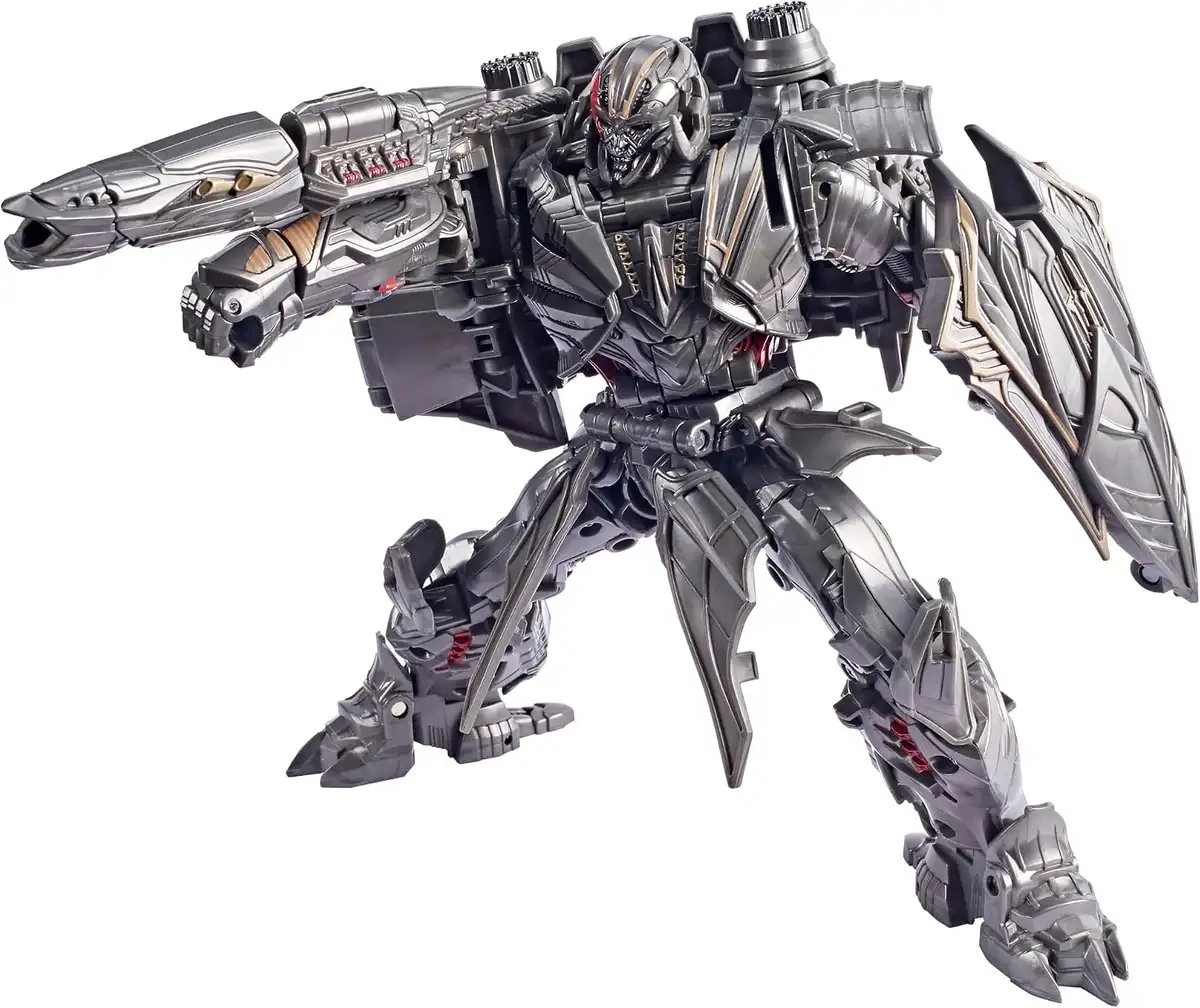 Megatron’s robot mode features dark silver armor with bronze trim and red mechanical details. His cannon and large shield are mounted on opposite arms.